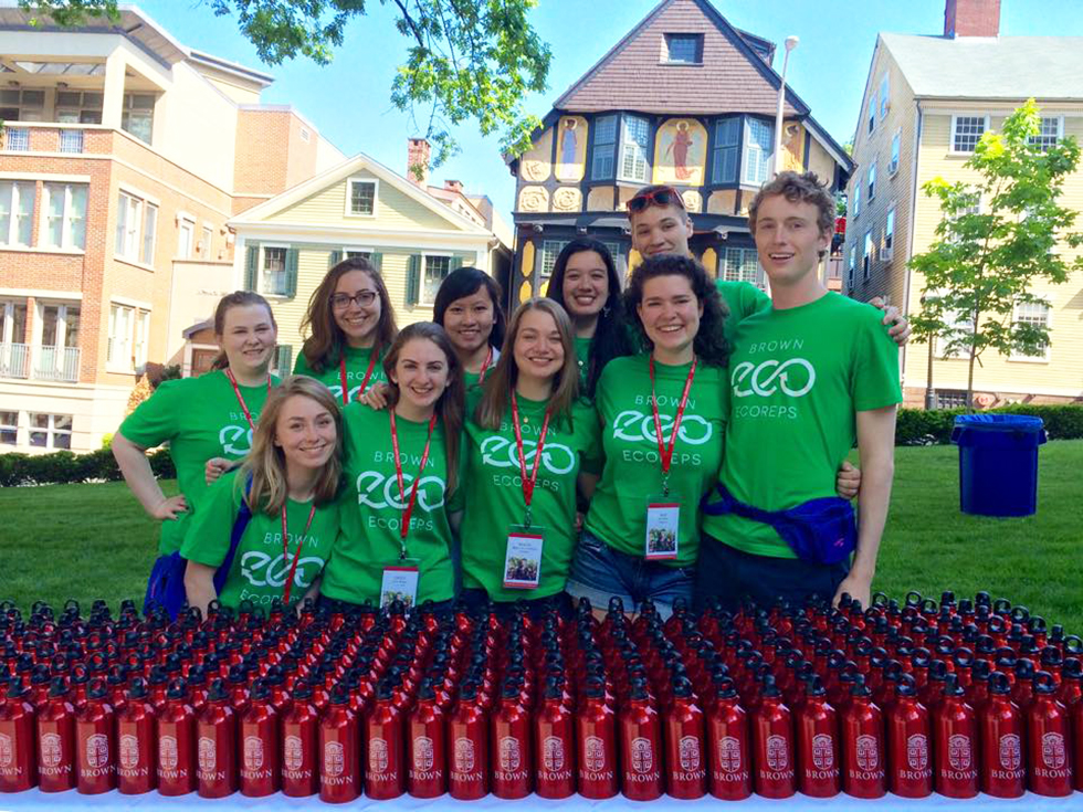 EcoReps members in green shirts behind table full of red metal water bottles