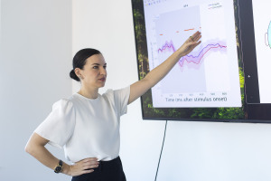 Frederike Petzschner gesturing to whiteboard graphs
