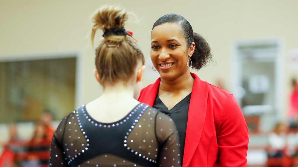 Gymnastics coach Brittany Harris faces a student