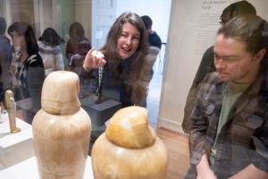 people look at artifacts in a case